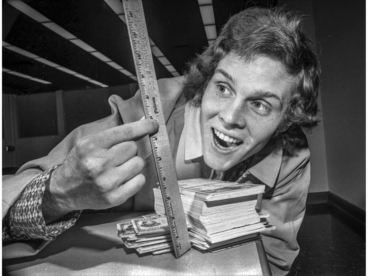 May 4, 1972: Jay North, 20, who played Dennis the Menace on the television series, measures his stack of savings bonds.