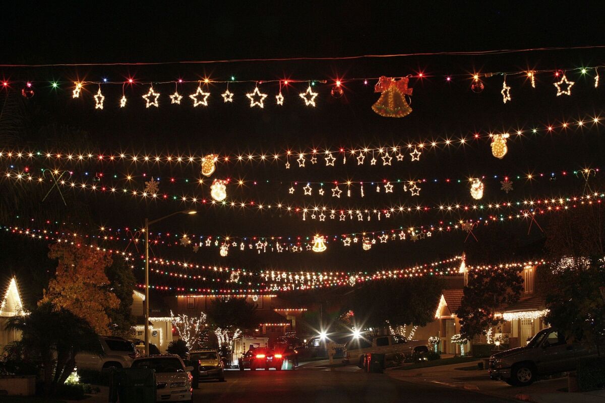 Christmas lights stretch across a street in Wagon Wheel, a hillside community in south Orange County.