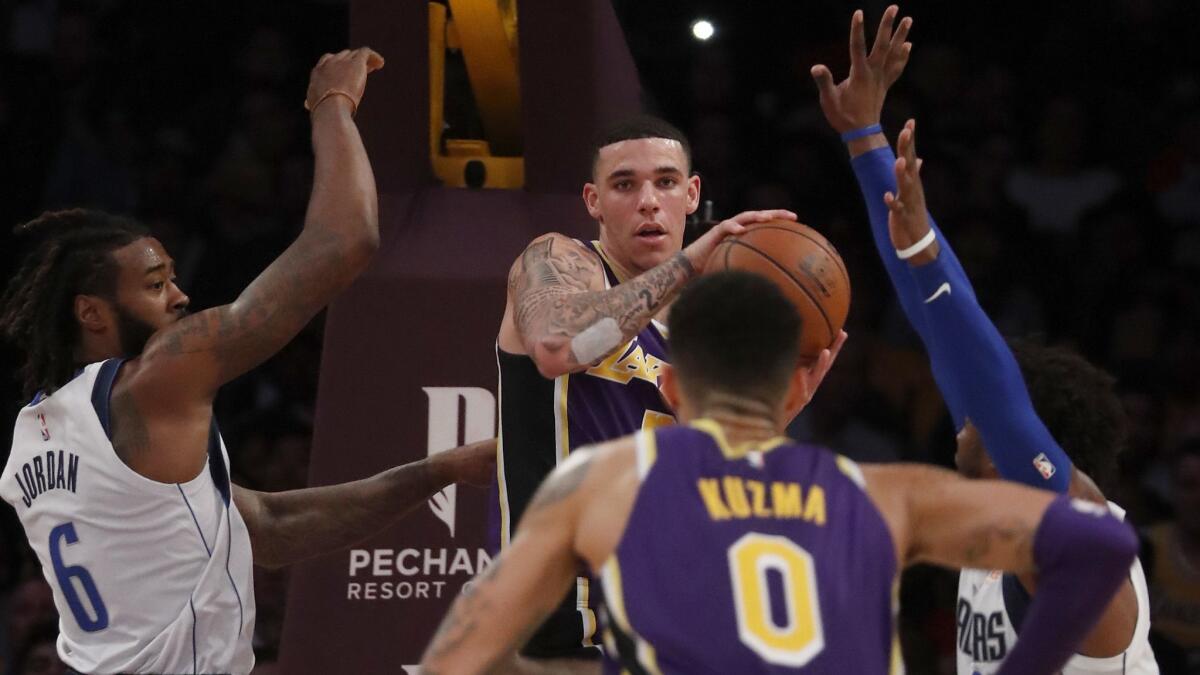 Lakers guard Lonzo Ball dishes an assist to teammate Kyle Kuzma.
