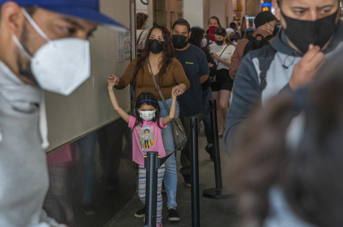 A line of masked customers in a food hall