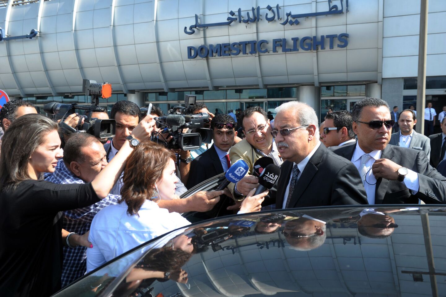 Egyptian Prime Minister Sherif Ismail talks to reporters at Cairo International Airport after the crash.