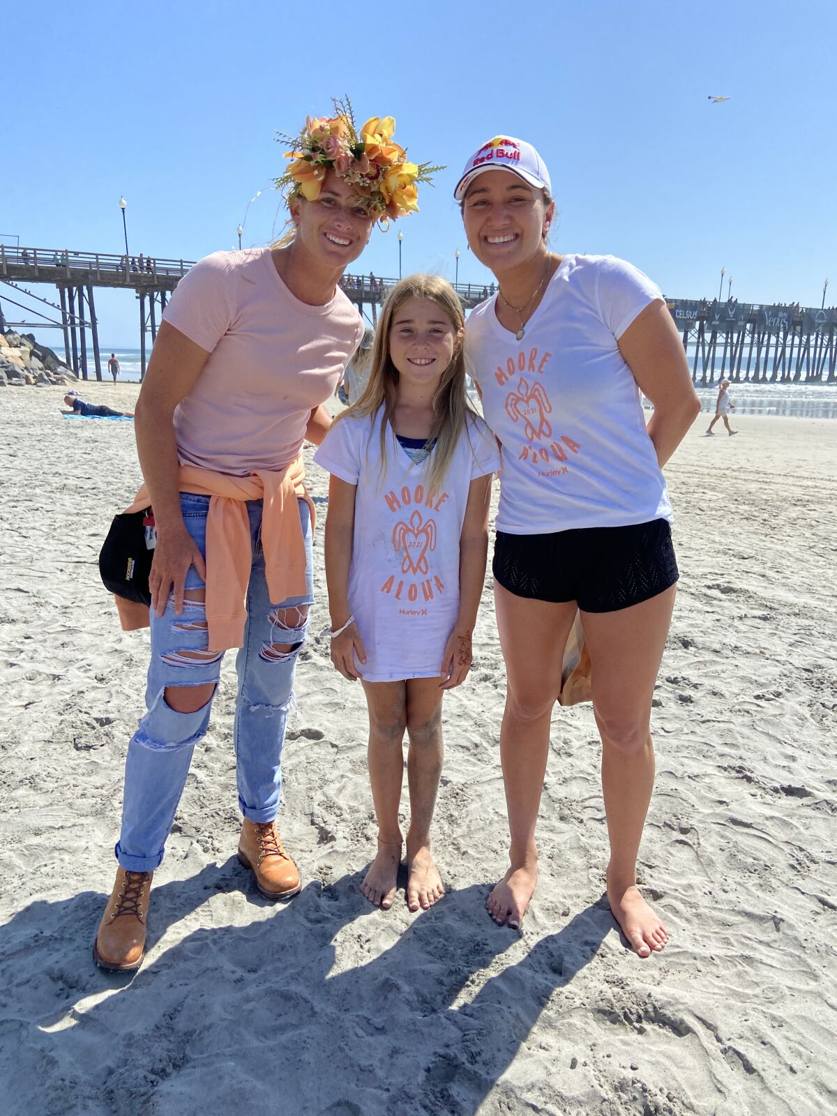 Pro surfer Lakey Peterson, La Jolla fifth-grader Catalina McDonnell and pro surfer Carissa Moore