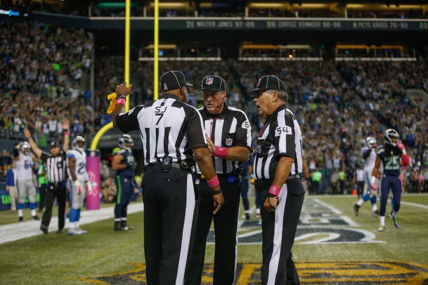 Officials confer abefore getting the call wrong after the ball was batted out of the end zone by Seattle's K.J. Wright during a game against Detroit on Monday night.