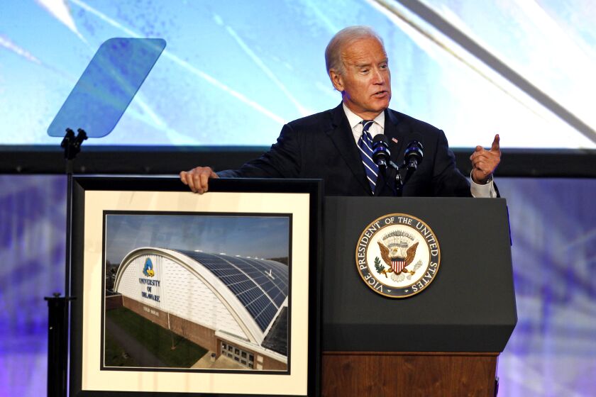 ANAHEIM, CALIF. -- WEDNESDAY, SEPTEMBER 16, 2015: Vice President Joe Biden displays a photo of solar panels mounted on the field house at the University of Delaware as he speaks at the Solar Power International (SPI) conference at the Anaheim Convention Center in Anaheim, Calif., on Sept. 16, 2015. (Allen J. Schaben / Los Angeles Times)