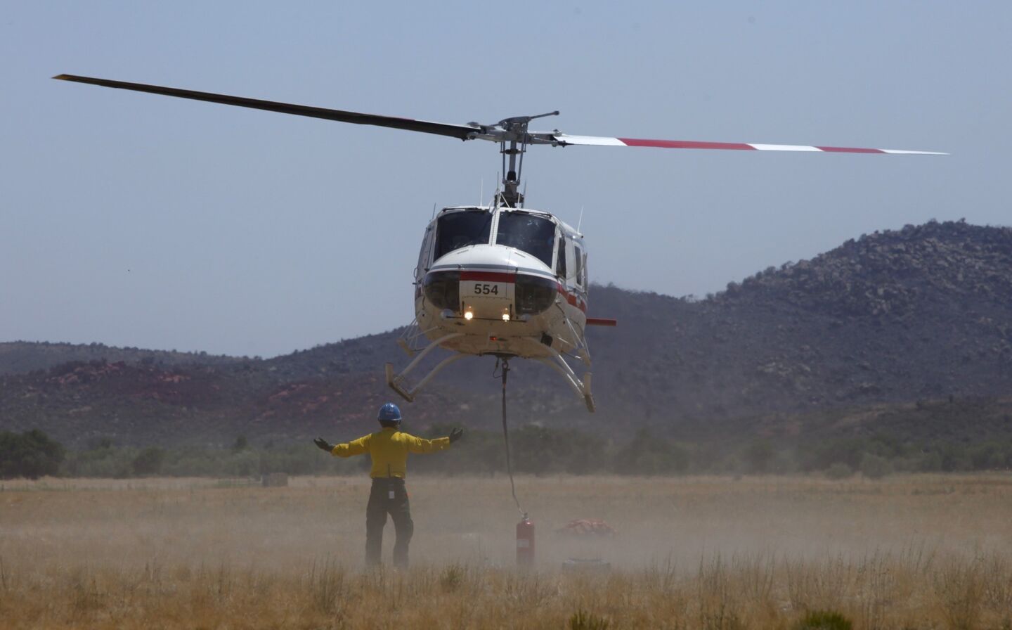 A water-dropping helicopter takes off in the Peeples Valley area, about five miles from Yarnell, where the 19 firefighters died.