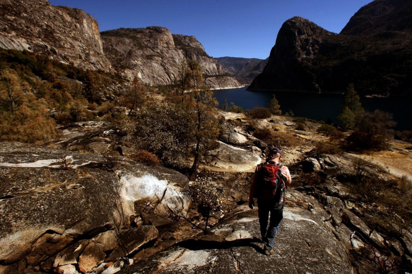 William Sears, a science and policy analyst with the Hetch Hetchy Regional Water System, walks along the Hetch Hetchy Reservoir. San Francisco officials are closely monitoring hydroelectric facilities, soil conditions and water quality in and around reservoir, where the Rim fire crept around the edges of the city's drinking water supply and made some areas more prone to erosion.