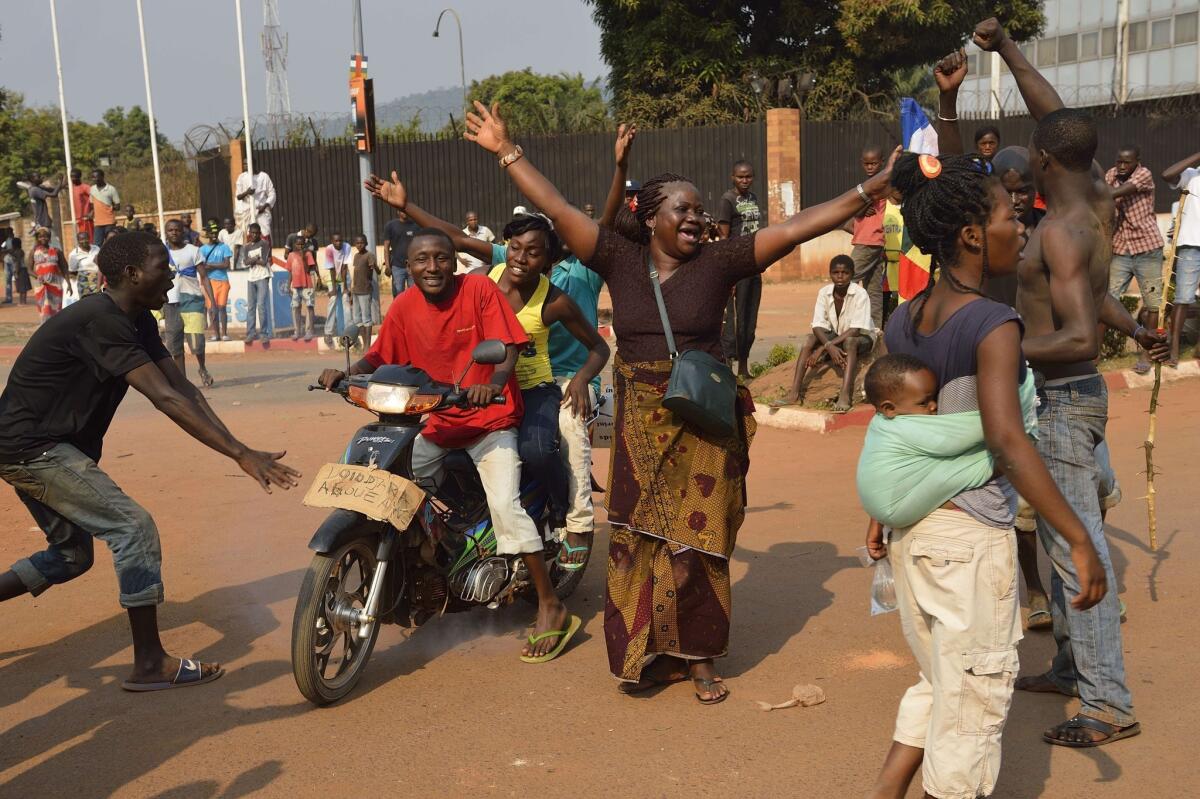 People celebrate in Bangui, capital of the Central African Republic, after the resignation of President Michel Djotodia was announced.