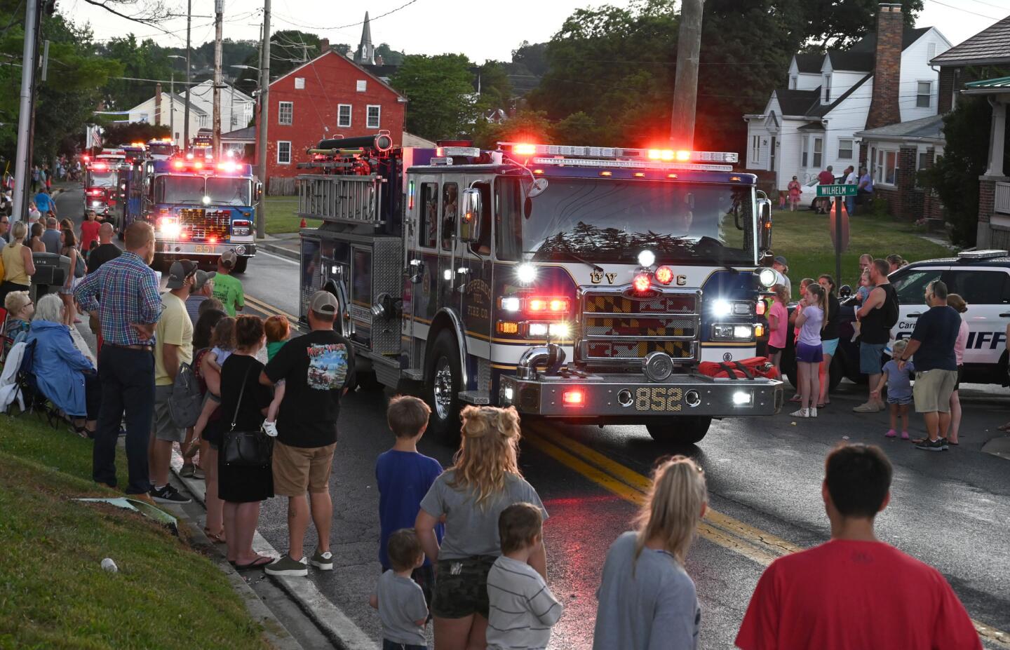 People line York Street to watch the parade leading to the Manchester Volunteer Fire Company carnvial on Tuesday, July 2.
