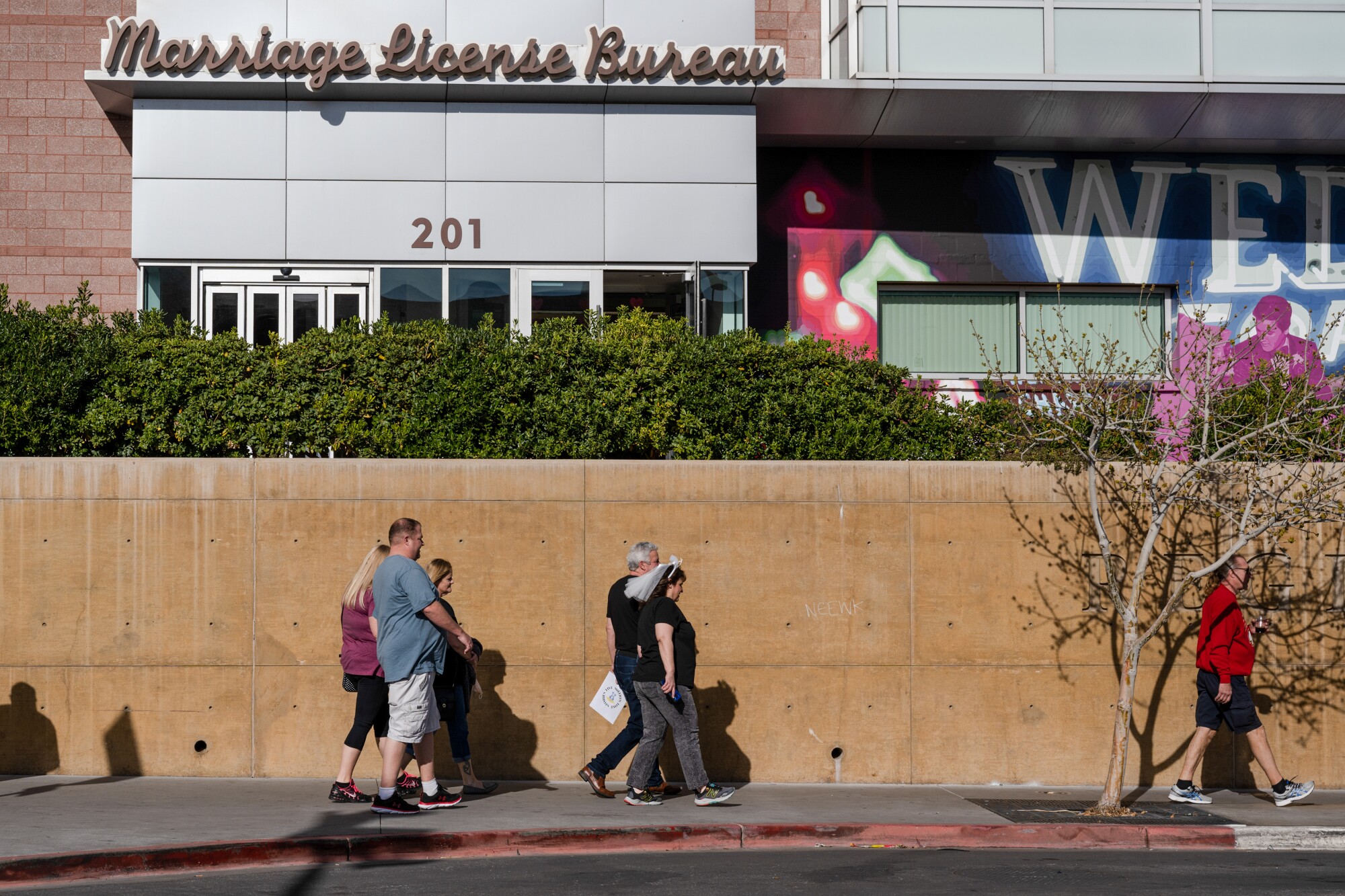 A woman wearing a white veil passes the Marriage License Bureau in Las Vegas