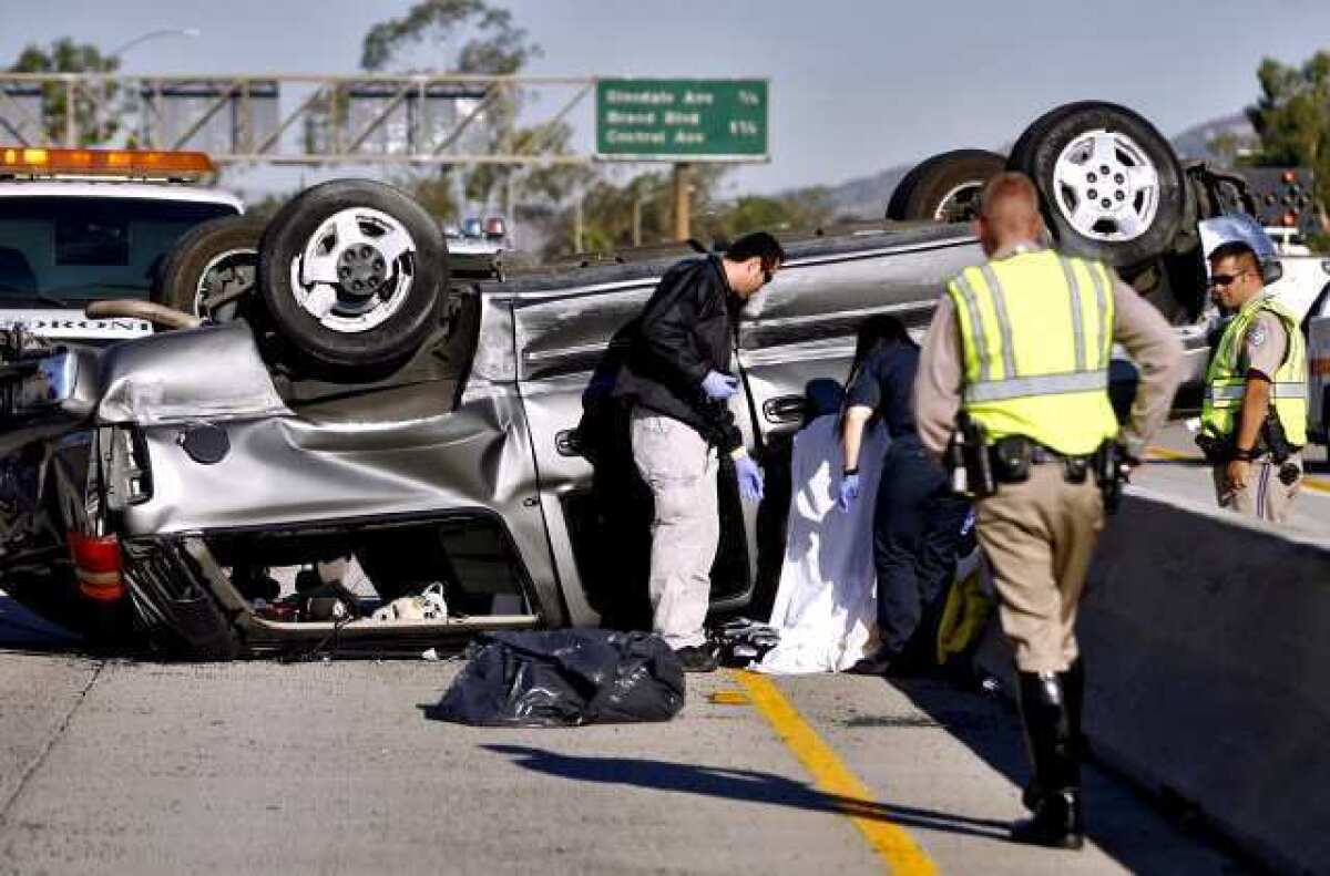 L.A. County Coroner's officials and California Highway Patrol officers investigate a fatal accident on the 134 Freeway west of the 2 Freeway in Glendale on Friday morning, Sept. 14, 2012. Traffic was snarled on both sides of the freeway.
