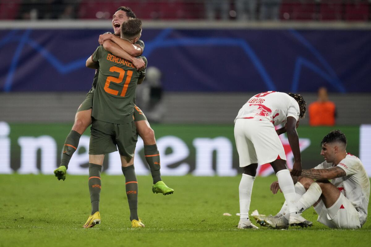 Shakhtar players celebrate at the end of the Champions League Group F soccer match between RB Leipzig and Shakhtar Donetsk, in Leipzig, Germany, Tuesday, Sept. 6, 2022. (AP Photo/Michael Sohn)