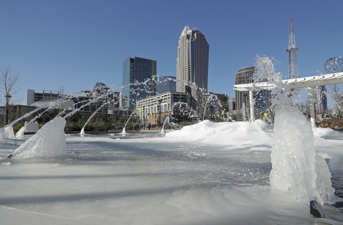Water squirts from a mostly frozen fountain in Charlotte, N.C.