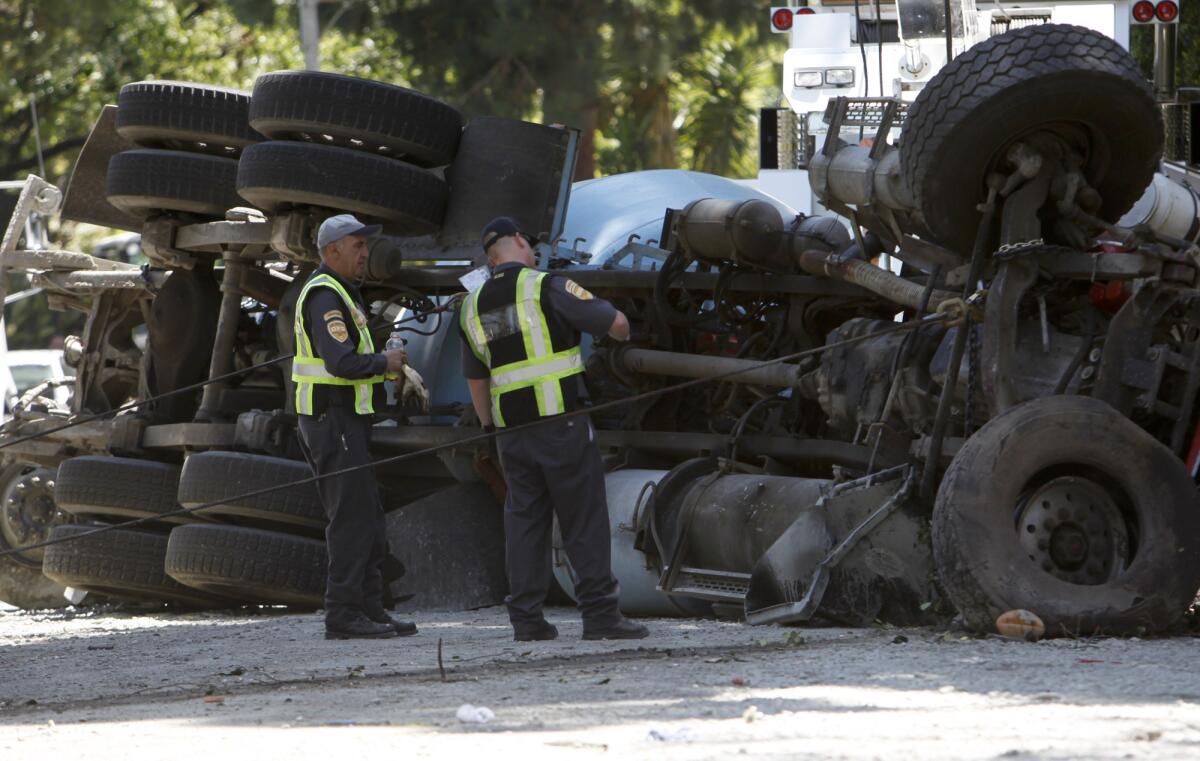 A cement truck hit several cars and flipped over on Loma Vista Drive in Beverly Hills.