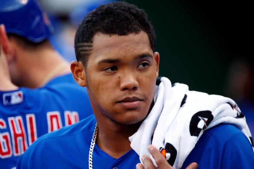 FILE - In this Aug. 4, 2015, file photo, Chicago Cubs' Addison Russell stands in the dugout during a baseball game against the Pittsburgh Pirates in Pittsburgh. Major League Baseball is looking into a domestic violence accusation against Russell. His wife, Melissa, posted a photo Wednesday on Instagram with a caption suggesting he was unfaithful to her. In another post, a user named carlierreed and described by Melissa as a close friend accused Russell of "mentally and physically abusing her." The posts have been deleted. Russell issued a statement Thursday, June 8,2 017, that said: "Any allegation I have abused my wife is false and hurtful. For the well-being of my family, I'll have no further comment." (AP Photo/Gene J. Puskar, File)