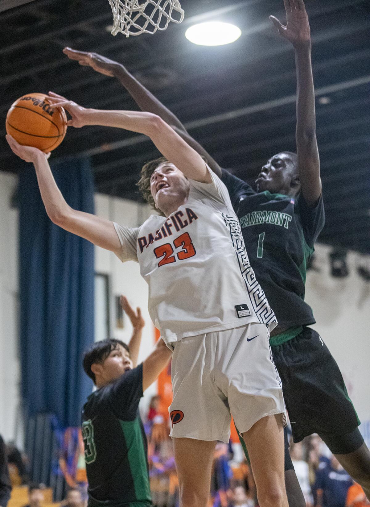 Pacifica Christian Orange County's Dylan Godfrey takes a shot under pressure from Fairmont Prep's Maper Maker.