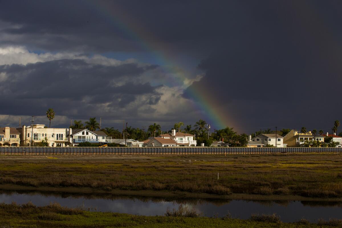 A double rainbow appears in the sky over Brookhurst Marsh in Huntington Beach on Monday.