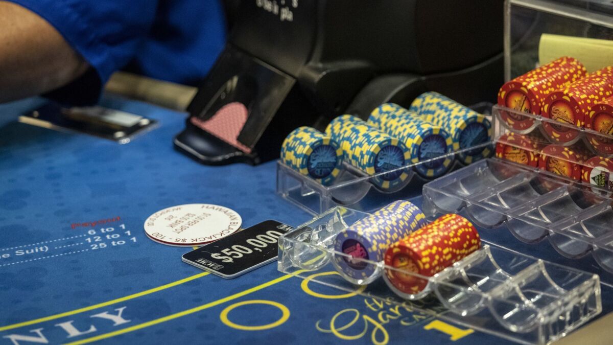 At card clubs in California, the dealer works for the casino but the players bet against a third-party banker, who has no financial ties to the casino. The state is considering adopting new regulations for card clubs.
