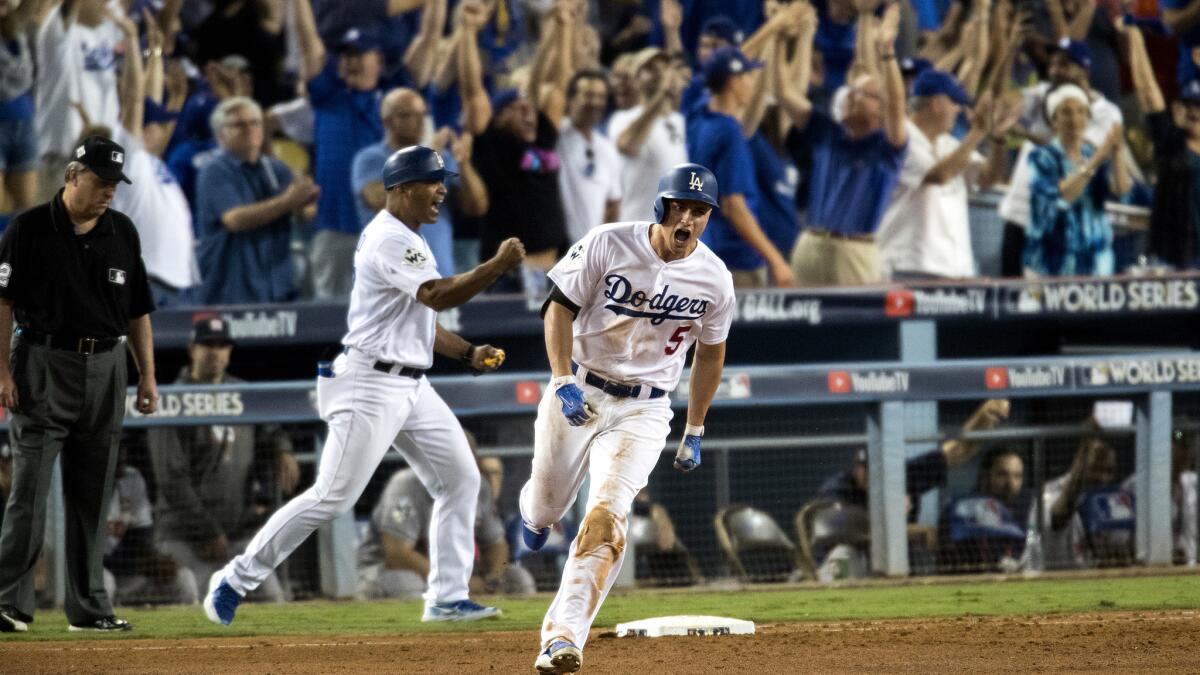 Dodgers shortstop Corey Seager celebrates as he rounds first base after hitting a two-run home run off Justin Verlander during the sixth inning of Game 2.