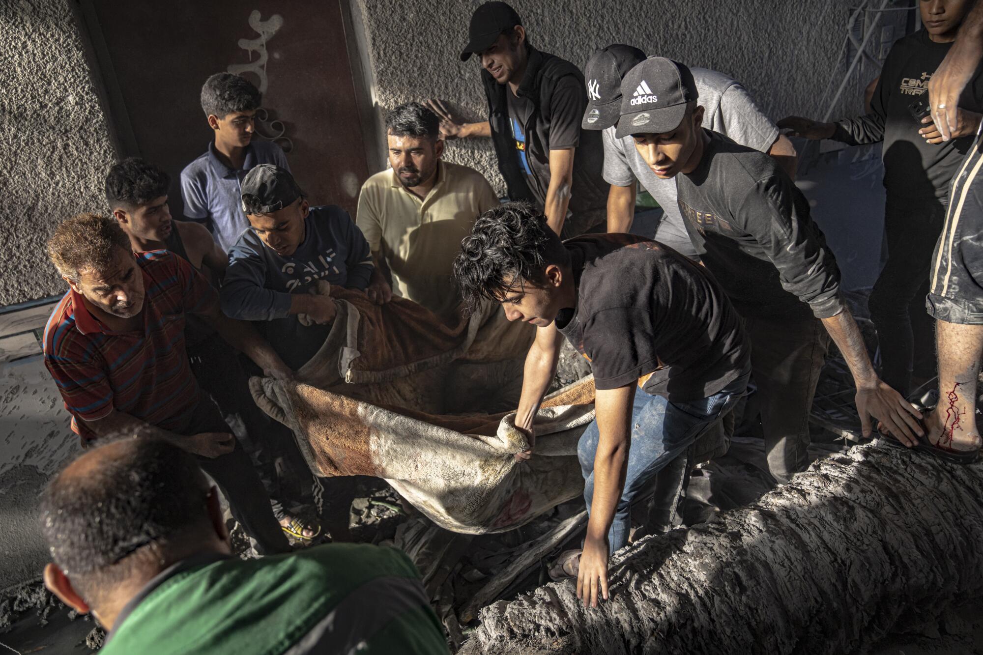 People evacuating man wounded in Israeli airstrike on Gaza