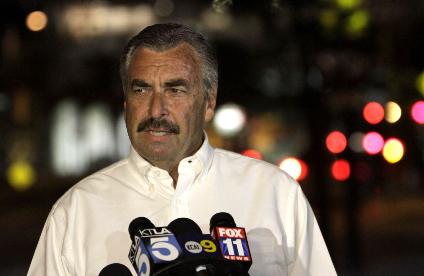 LAPD Chief Charlie Beck speaks to the media about the condition of the injured officer at Cedars-Sinai Medical Center on Monday night. "He is in great spirits," Beck said. He described the officer as a "remarkable young man" who was "very, very lucky."