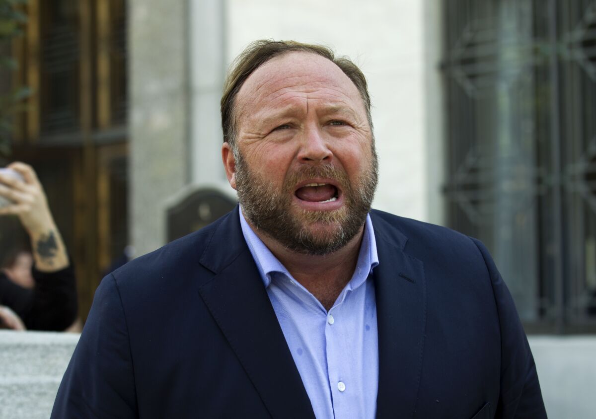 FILE - Alex Jones speaks to reporters in Washington, Sept. 5, 2018. Infowars filed for Chapter 11 bankruptcy protection on Sunday, April 17, 2022, in Texas as its founder and conspiracy theorist Alex Jones faces defamation lawsuits over his comments that the Sandy Hook Elementary School shooting was a hoax. (AP Photo/Jose Luis Magana, File)