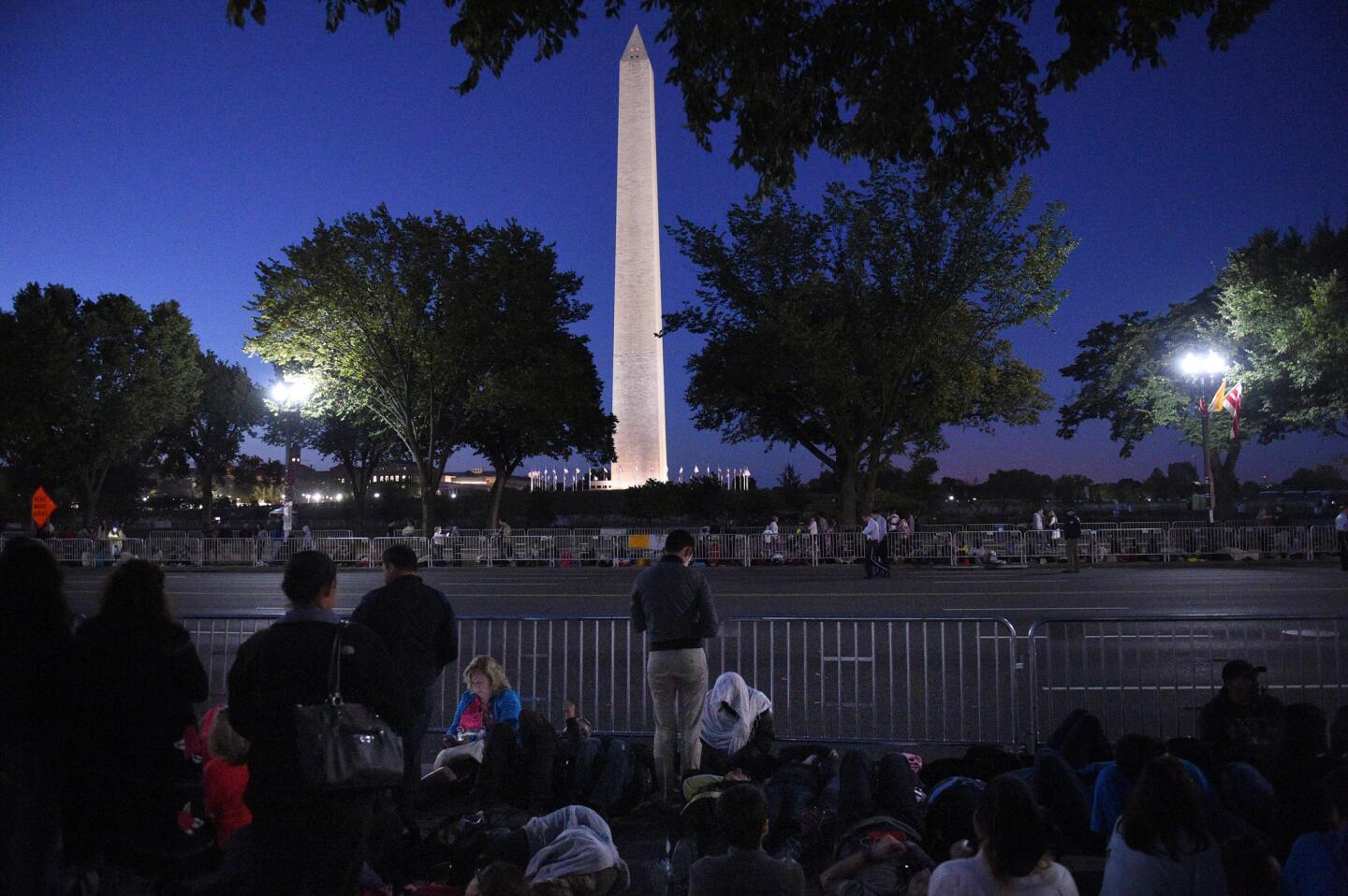 Spectators wait as early as 5 a.m. along the parade route of Pope Francis around the Ellipse, south of the White House, on Sept. 23, 2015.