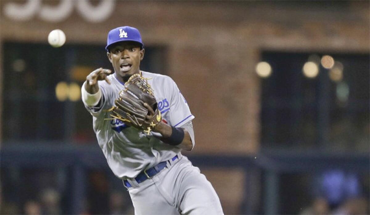 Shortstop Dee Gordon makes an off-balance throw to first to get San Diego's Tommy Medica out during the Dodgers' 2-0 loss to the Padres on Friday.