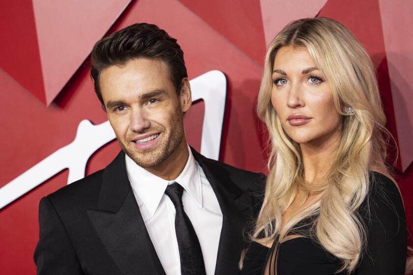 Liam Payne and Kate Cassidy pose for photographers at the British Fashion Awards