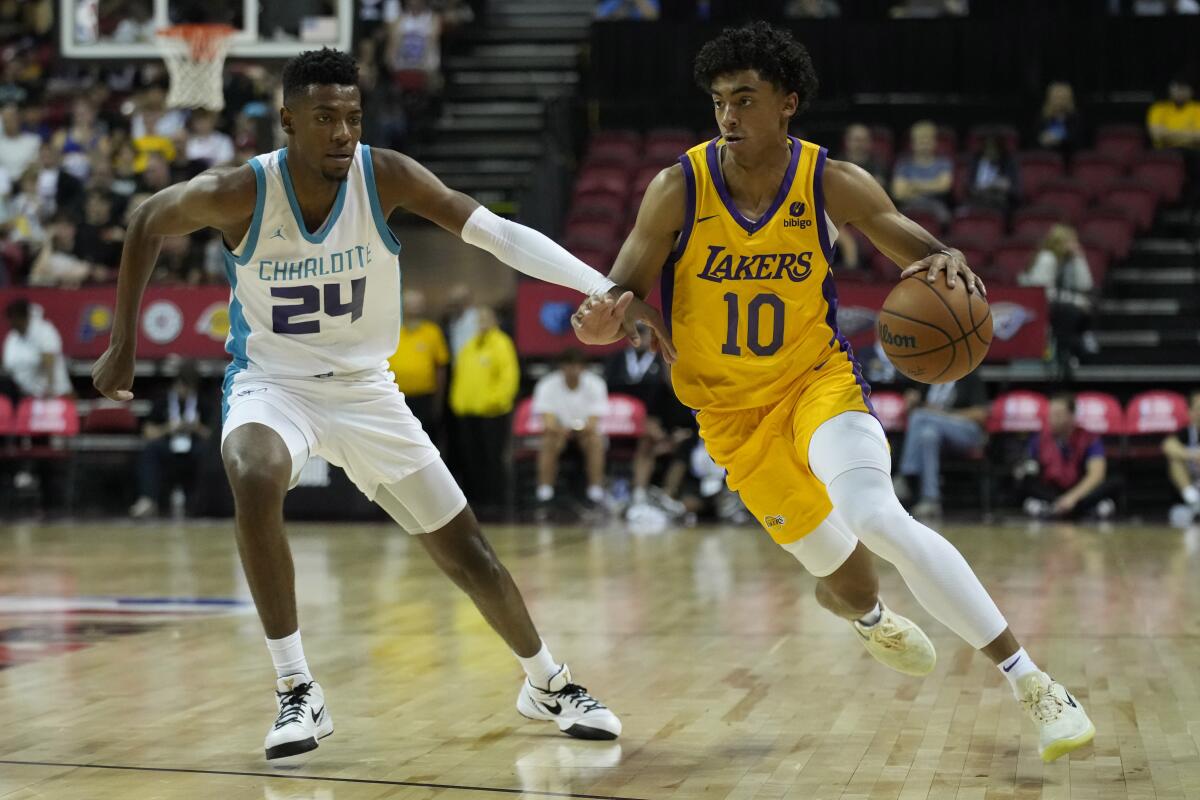 Lakers' Max Christie drives against Charlotte Hornets' Brandon Miller.