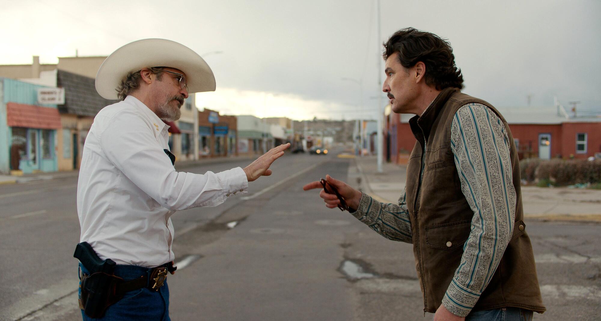 Two men argue on the street of a southwestern American town during the pandemic.