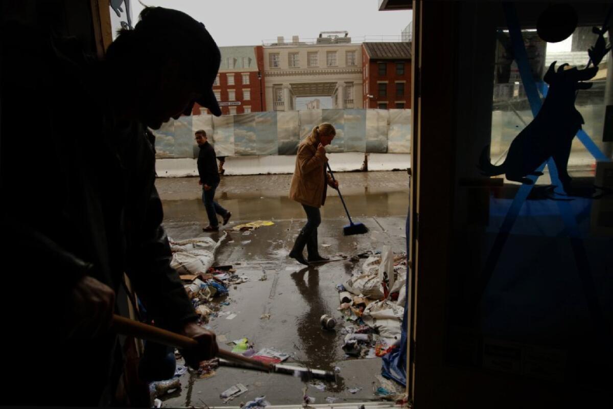 People clean up a store in lower Manhattan after Superstorm Sandy in 2012.