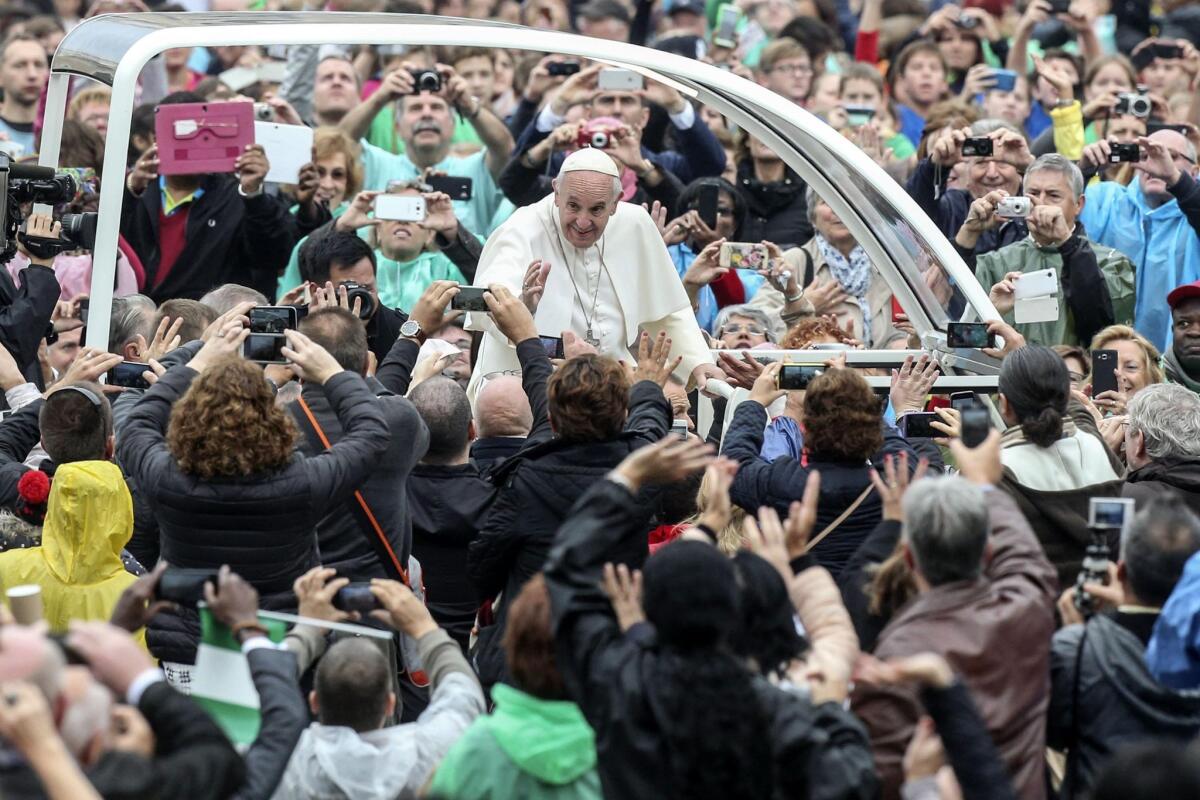 Pope Francis greets visitors in St. Peter's Square at the Vatican. The pope has a new book deal with Random House. "The Name of God Is Mercy: A Conversation with Andrea Tornielli" is to be released in January.