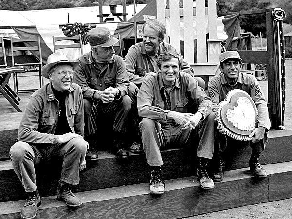 Cast members of the television series "MASH" take a break. From left, William Christopher, Harry Morgan, Mike Farrell, Alan Alda, and Jamie Farr.