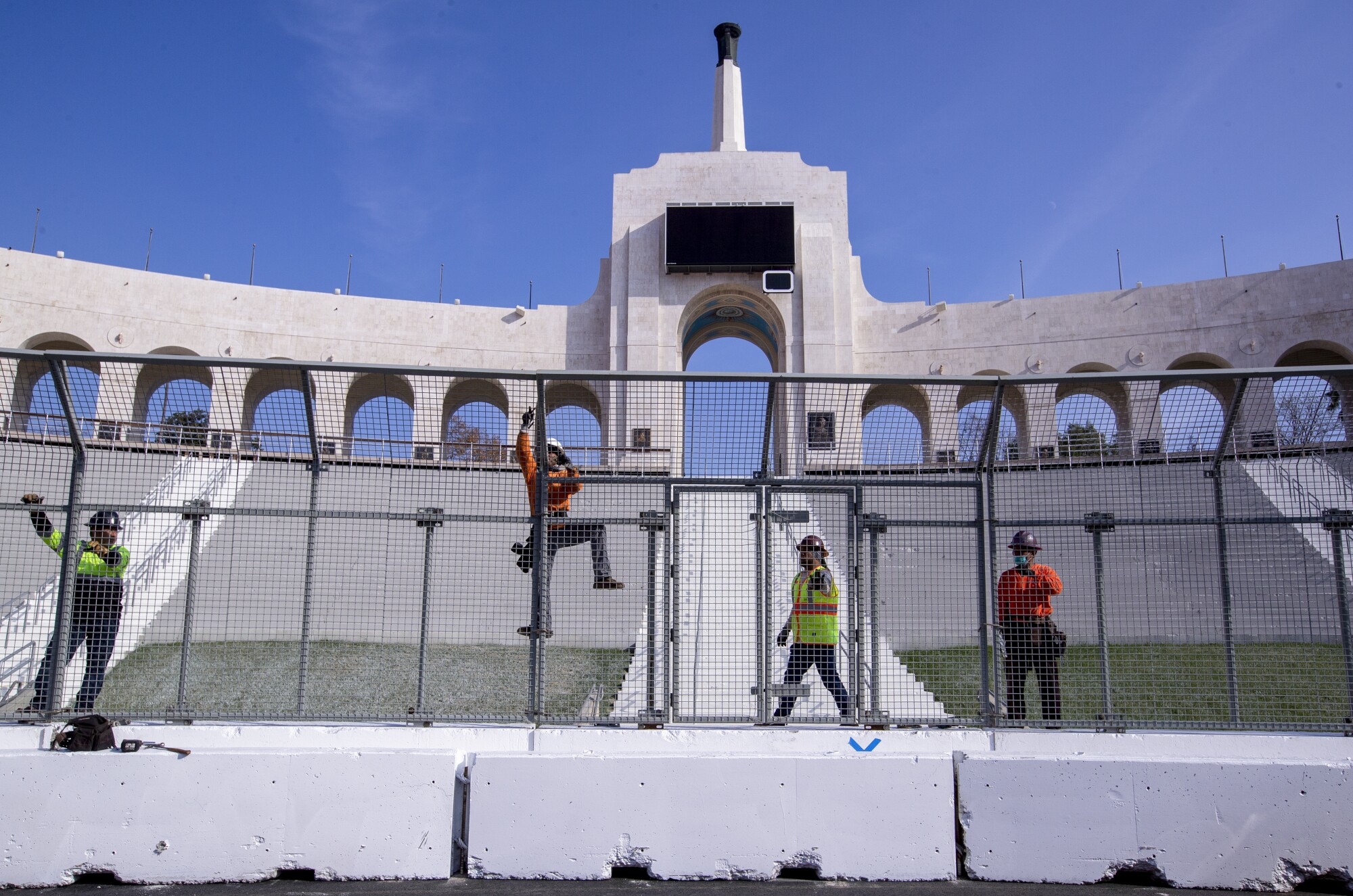 Construction crews transform the Coliseum to a quarter-mile short track NASCAR exhibition race