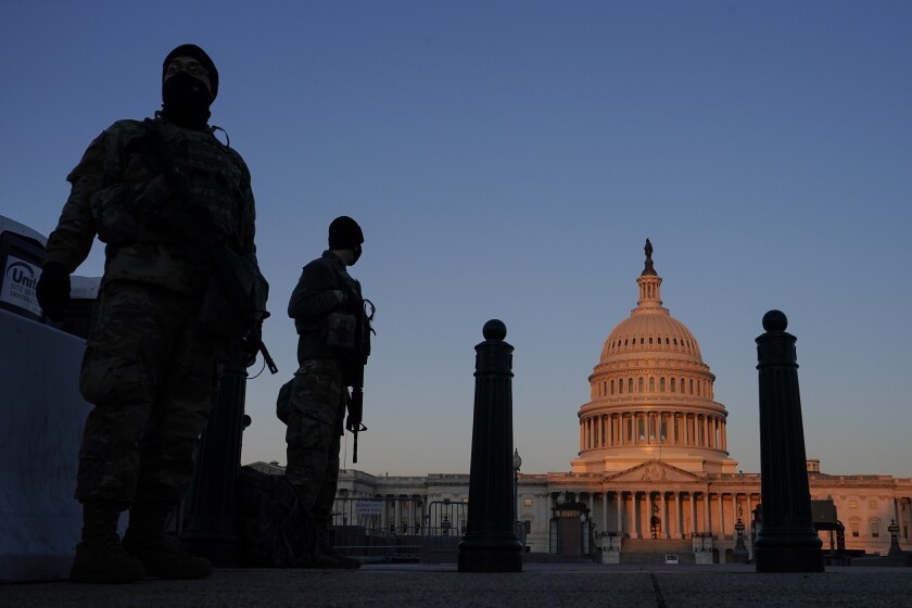 National Guard stand their posts around the Capitol at sunrise in Washington, Monday, March 8, 2021. (AP Photo/Carolyn Kaster)