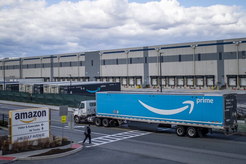 FILE - A truck arrives at the Amazon warehouse facility on the Staten Island borough of New York, April 1, 2022. Amazon has suspended at least 50 warehouse workers who refused to work their shifts following a trash compactor fire at one of its New York facilities, according to union organizers. The company suspended the workers, with pay, on Tuesday, Oct. 4, 2022 a day after the fire disrupted operations at the Staten Island warehouse that voted to unionize earlier this year. (AP Photo/Eduardo Munoz Alvarez, File)