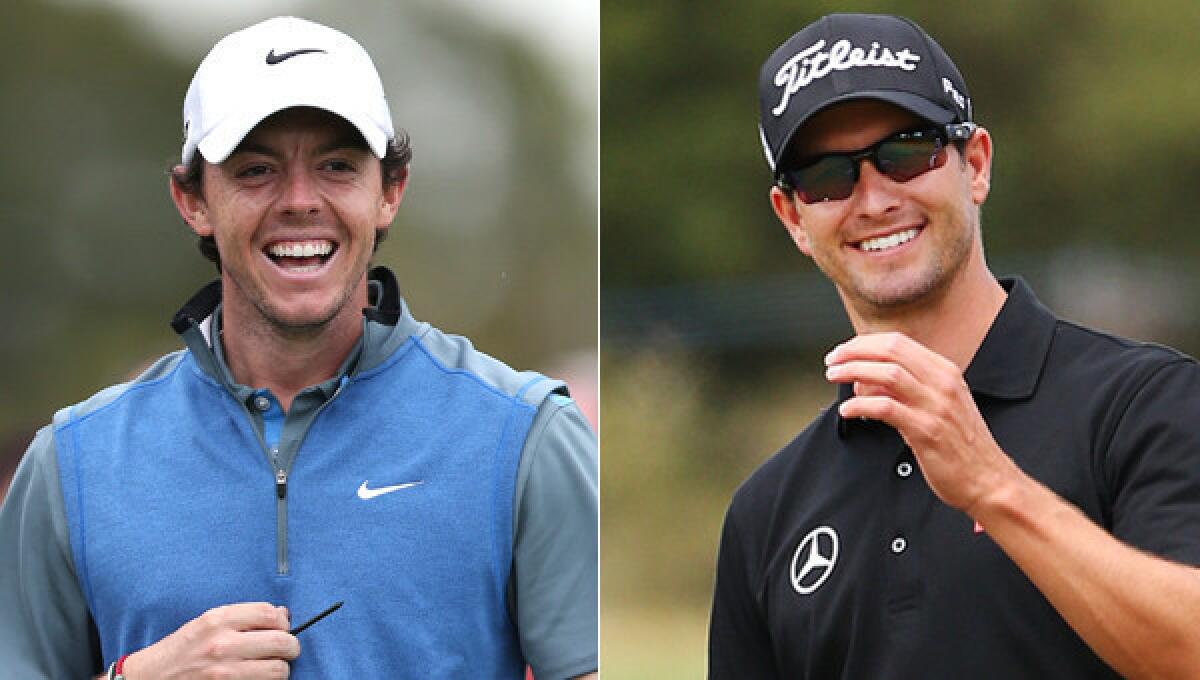 Adam Scott, right, leads Rory McIlroy by two strokes following the second round of the Australian Open.