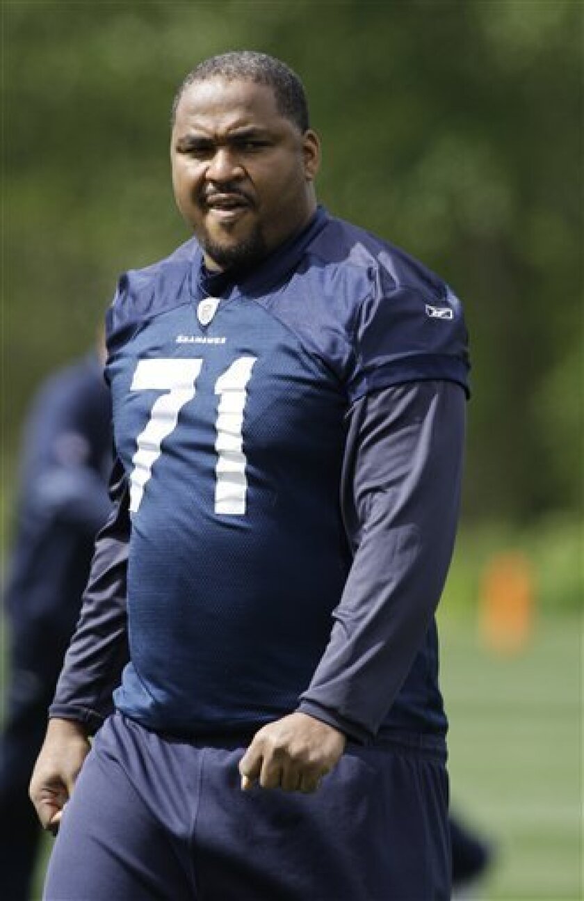 Seattle Seahawks tackle Walter Jones walks back into the Seahawks training facility after stretching with the NFL football team prior to an "organized team activity" Thursday, May 7, 2009, in Renton, Wash. Jones is coming off major knee surgery and is likely out until at least training camp in late July. (AP Photo/Ted S. Warren)