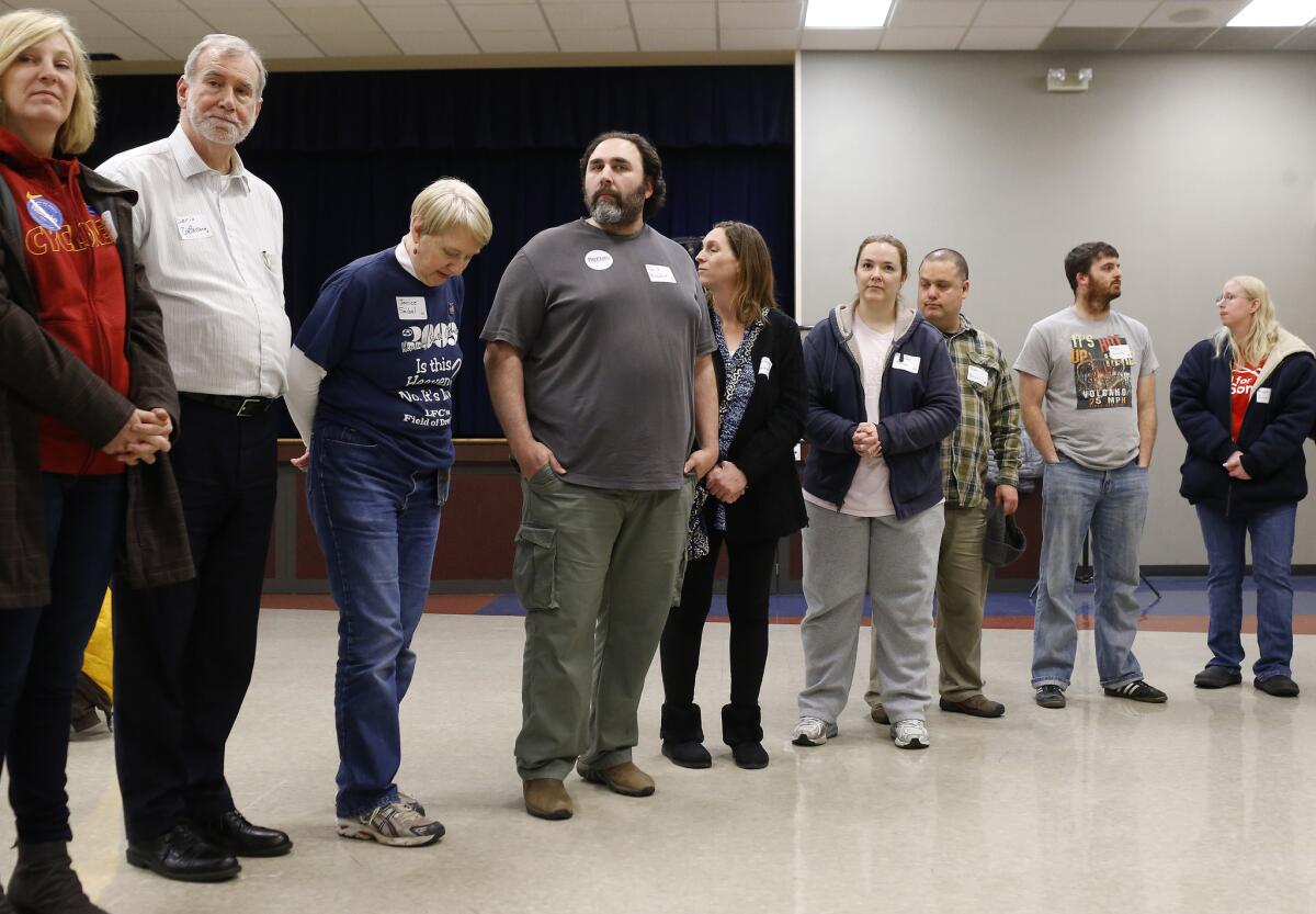 Supporters of candidate Bernie Sanders stand in line while they are counted during a Democratic Party caucus in Nevada, Iowa, on Monday.