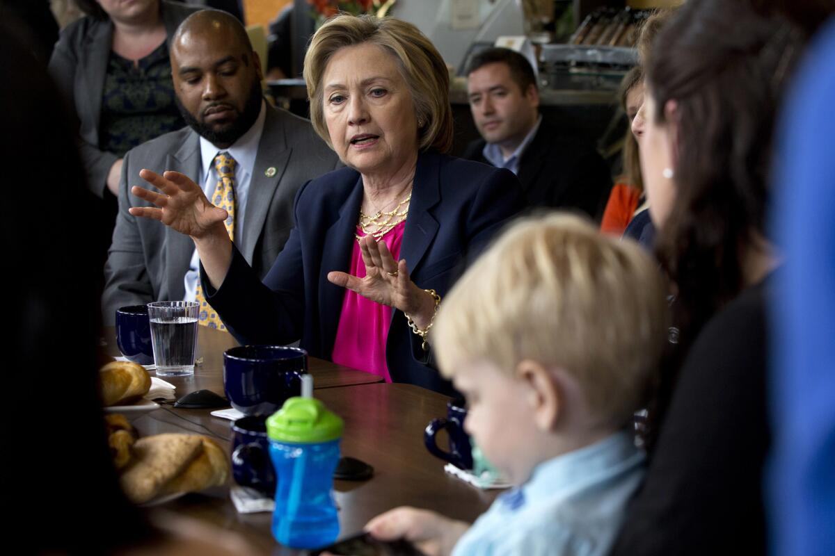 Democratic presidential candidate Hillary Clinton speaks with parents of young children in Stone Ridge, Va., on Monday.