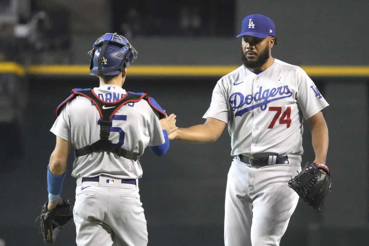 Dodgers catcher Austin Barnes and pitcher Kenley Jansen shake hands.