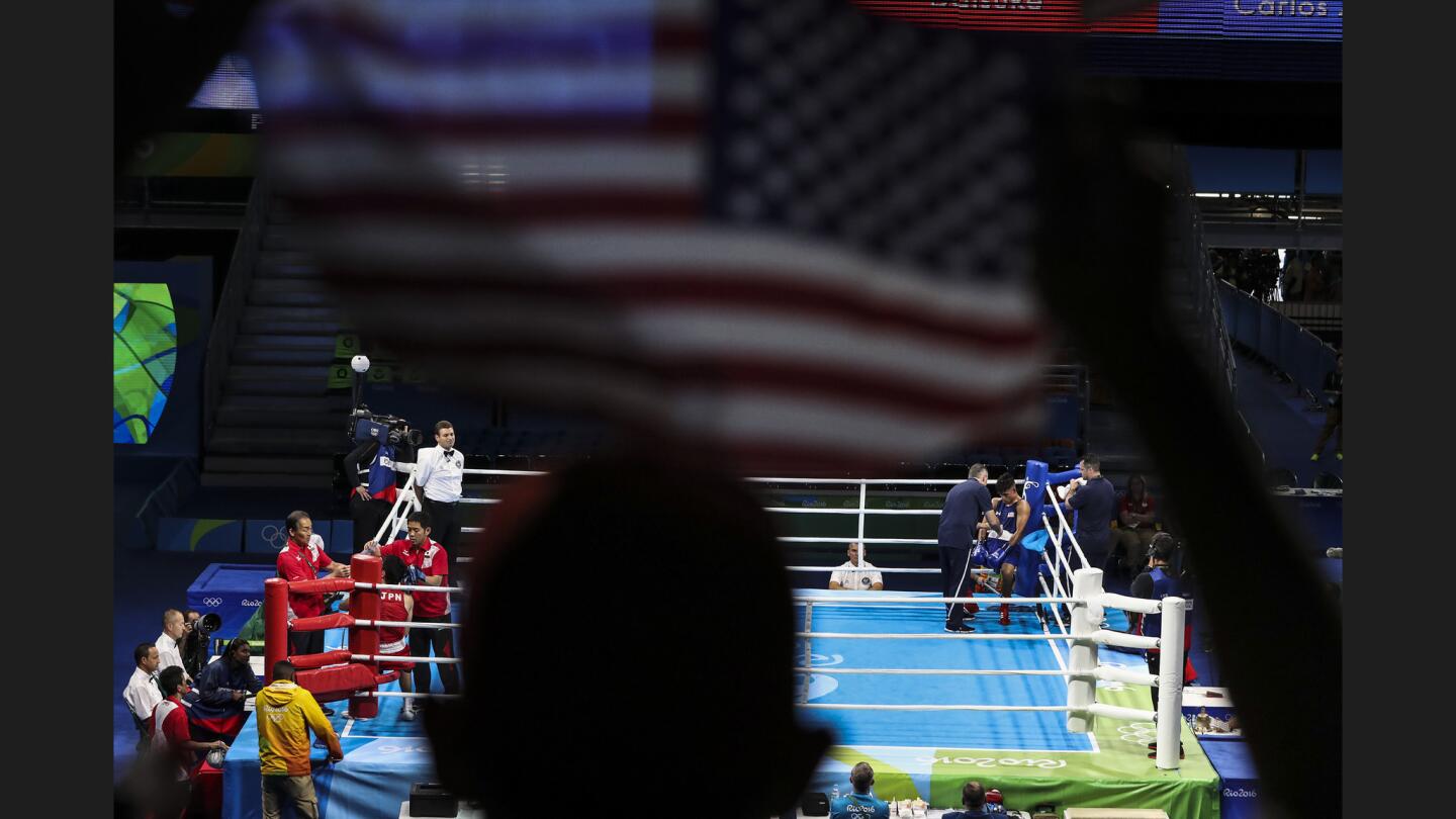 RIO DE JANEIRO, BRAZIL, TUESDAY, AUGUST 9 2016. - U.S. boxer Carlos Balderas Jr. is tended to in his corner between rounds against Japan's Daisuke Narimatsu in a Men's Light (60kg) prelim at Riocentro Pavilion 6. (Robert Gauthier/Los Angeles Times)