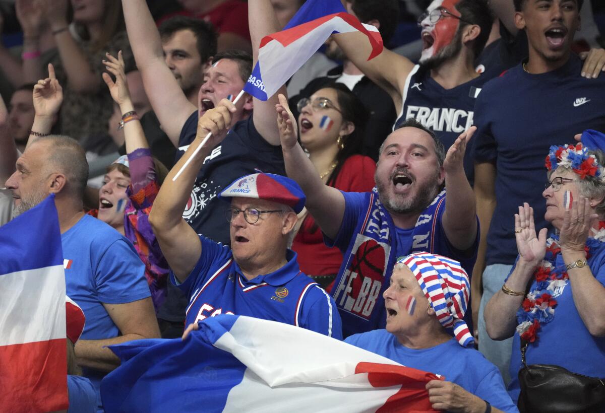 Supporters of the team of France celebrate during the Eurobasket semi final basketball match between Poland and France in Berlin, Germany, Friday, Sept. 16, 2022. France defeated Poland by 95-54. (AP Photo/Michael Sohn)