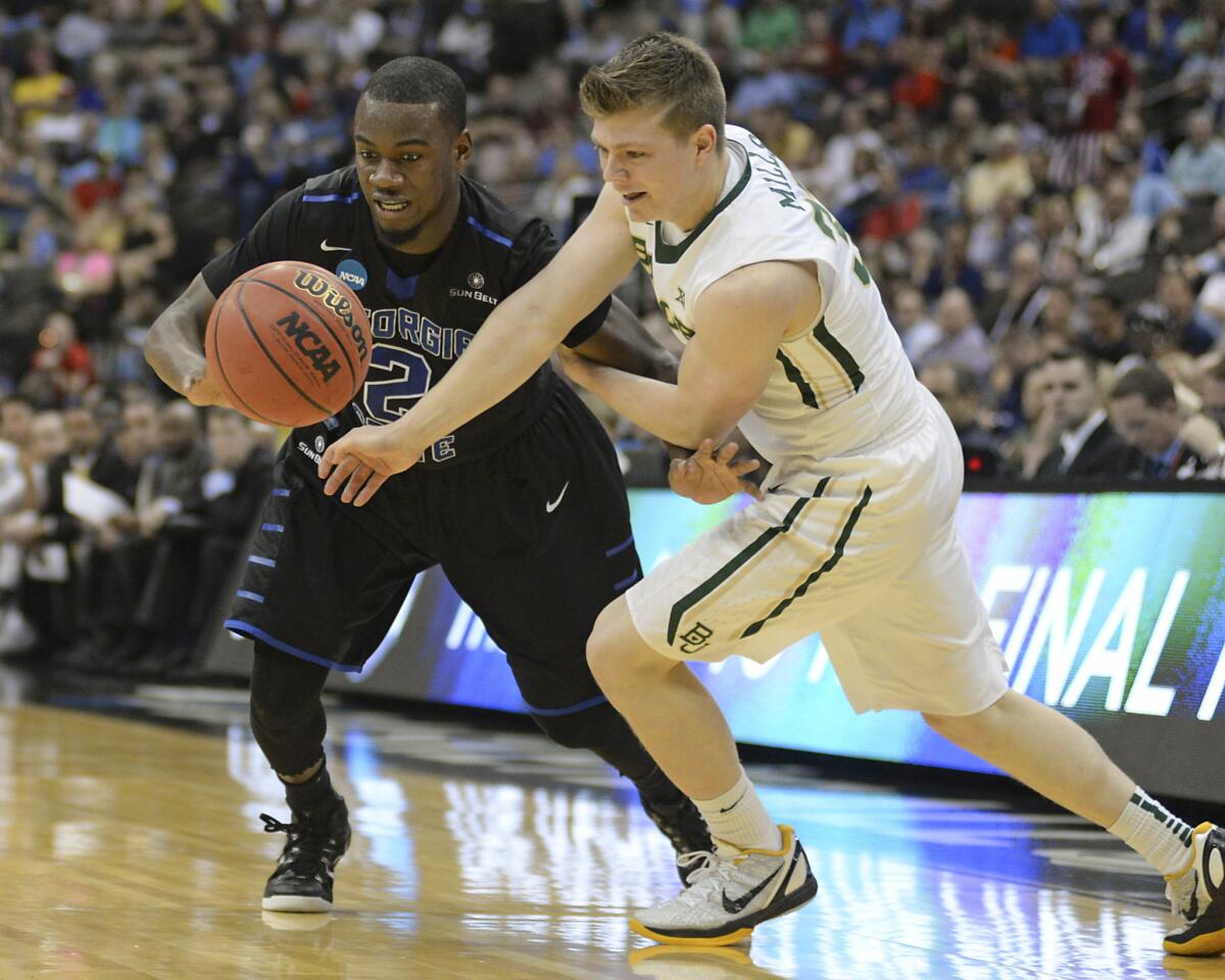 Georgia State guard Ryann Green and Baylor guard Austin Mills, right, chase a loose ball during the second half of the Panthers' NCAA tournament victory over the Bears, 57-56.