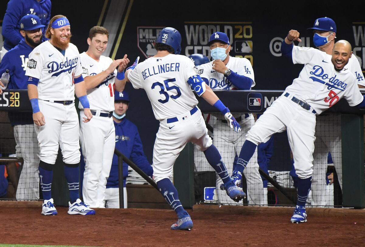 Cody Bellinger celebrates with his teammates in the dugout after hitting a two-run home run in the fourth inning.
