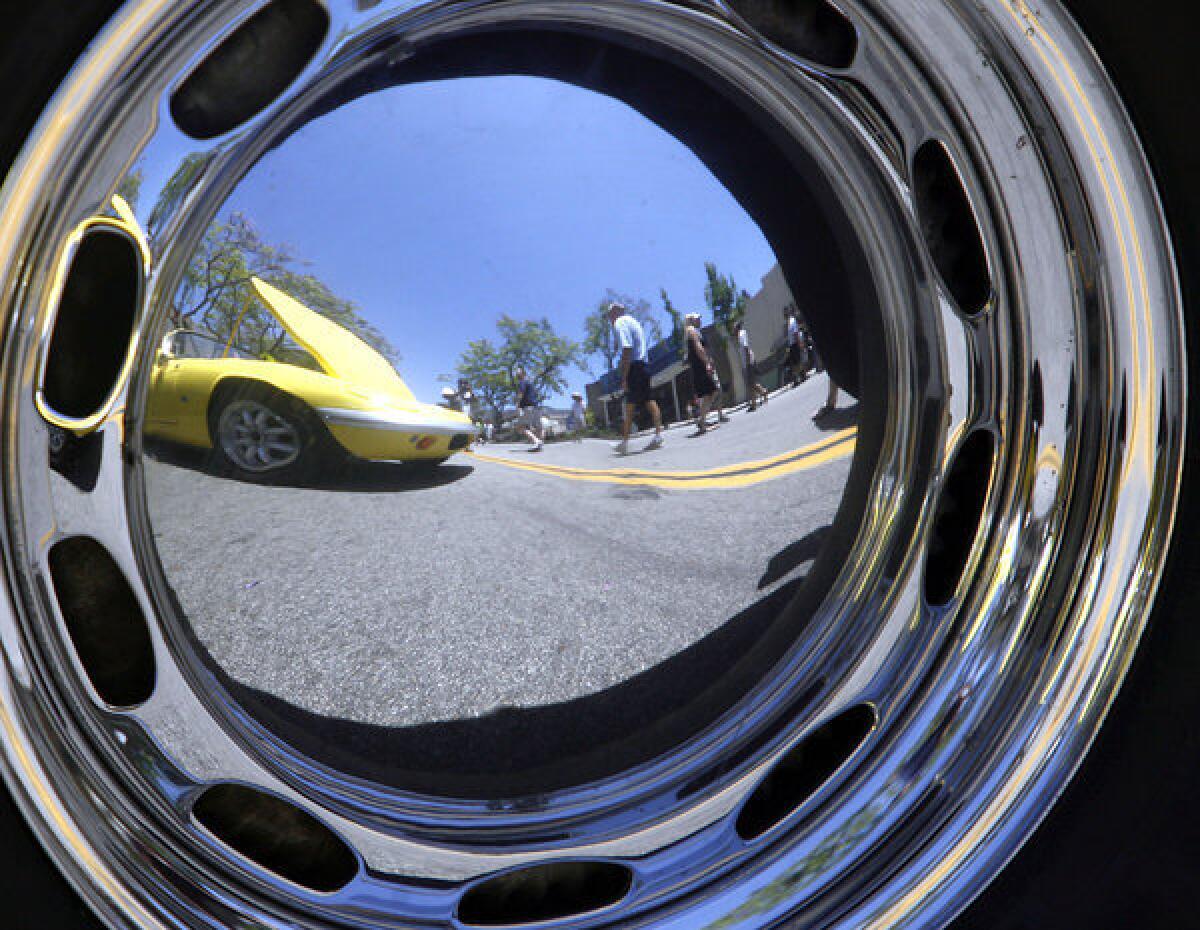 A classic Lotus is reflected on the hubcap of a 1962 Porsche at the Montrose Invitational Car Show in Montrose on Saturday.