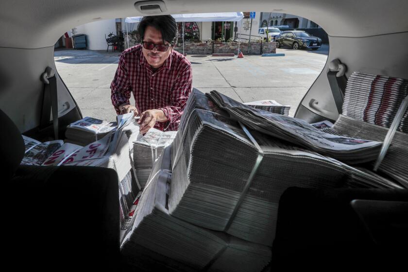 Monterey Park, CA, Wednesday, February 17, 2021 - Thakhin Kai Bwor of Canoga Park is a Web security specialist by day moonlights as the editor of the only Burmese-language newspaper in the U.S. He delivers bundles of the paper from the back of his Nissan Rogue. (Robert Gauthier/Los Angeles Times)