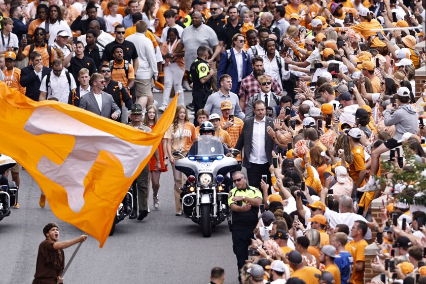 Tennessee head coach Josh Heupel and players greet fans during the traditional Vol Walk before an NCAA college football game against Florida Saturday, Sept. 24, 2022, in Knoxville, Tenn. (AP Photo/Wade Payne)