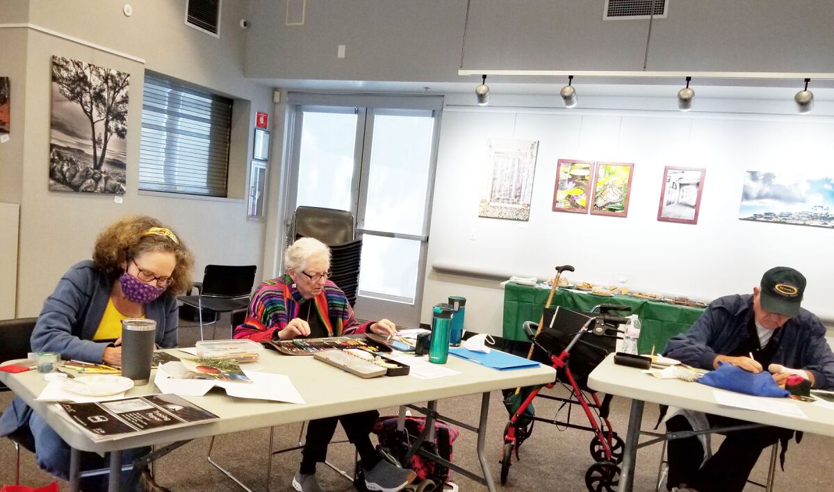 Darcy Lohmann, Katherine Miller and Al Meloche working on their art during a San Diego Chapter meeting in Pacific Beach.