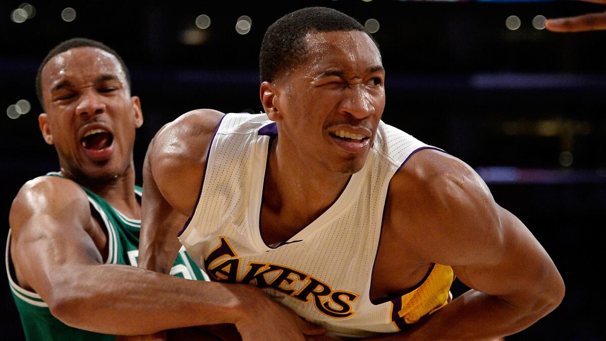 Lakers small forward Wesley Johnson tries to steal the ball from Boston Celtics point guard Avery Bradley during the Lakers' win back in February.